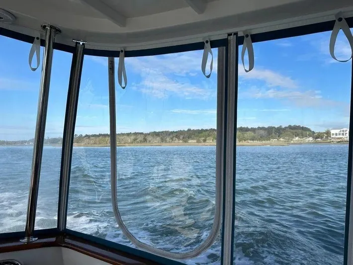 Carmella Yacht Photos Pics View from Kadey-Krogen 44AE boat, 2019 model, overlooking serene waters and distant shoreline.