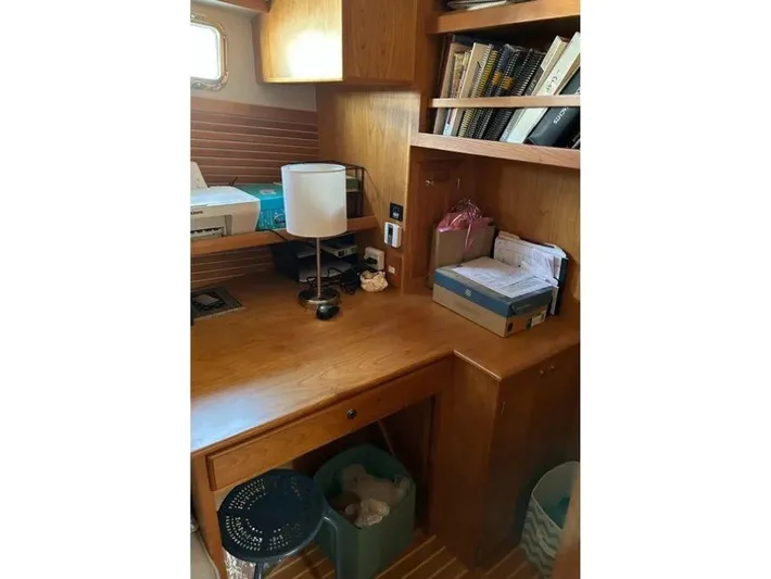 Carmella Yacht Photos Pics Cozy wooden desk area with bookshelves in a 2019 Kadey-Krogen 44AE yacht.