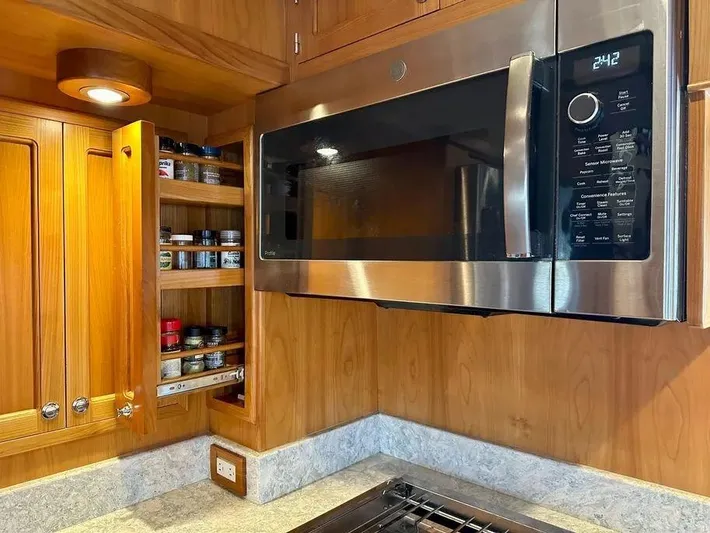 Carmella Yacht Photos Pics Modern Kadey-Krogen 44AE 2019 yacht kitchen with microwave and spice rack.