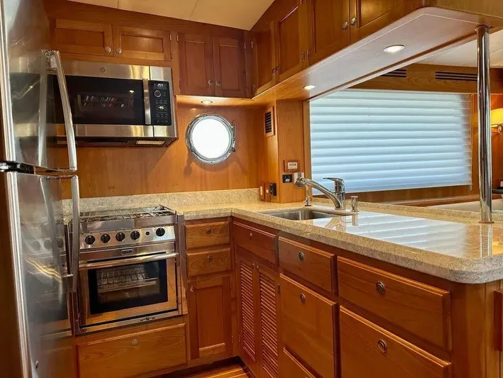 Carmella Yacht Photos Pics Luxurious 2019 Kadey-Krogen 44AE yacht kitchen with wood cabinetry and modern appliances.