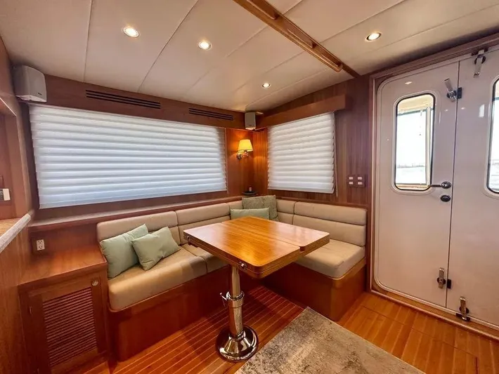 Carmella Yacht Photos Pics 2019 Kadey-Krogen 44AE yacht interior with cozy seating and wooden table.