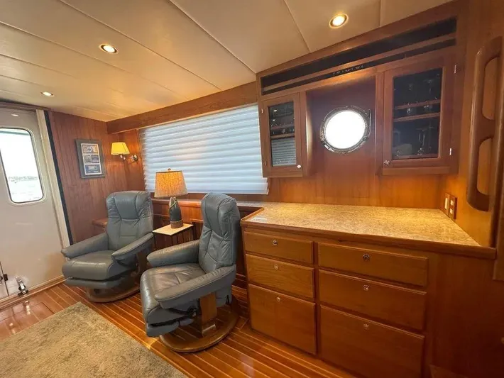 Carmella Yacht Photos Pics Luxurious Kadey-Krogen 44AE 2019 yacht interior with leather chairs and wooden cabinetry.