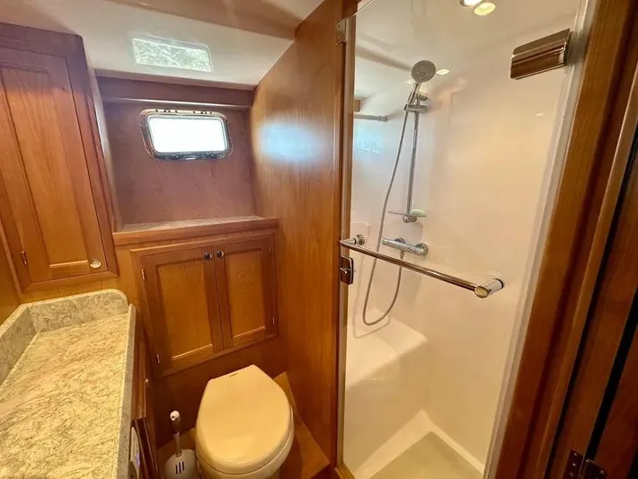 Carmella Yacht Photos Pics Luxurious 2019 Kadey-Krogen 44AE yacht bathroom with wood cabinetry and modern shower.