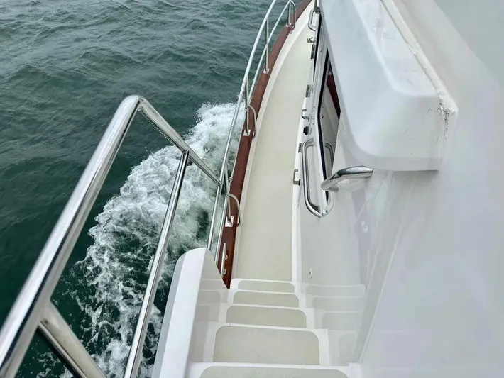 Carmella Yacht Photos Pics 2019 Kadey-Krogen 44AE yacht deck with railing, cruising on open water.