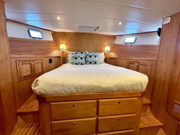 Carmella Yacht Photos Pics Luxurious 2019 Kadey-Krogen 44AE yacht bedroom with cozy bed and wooden cabinetry.