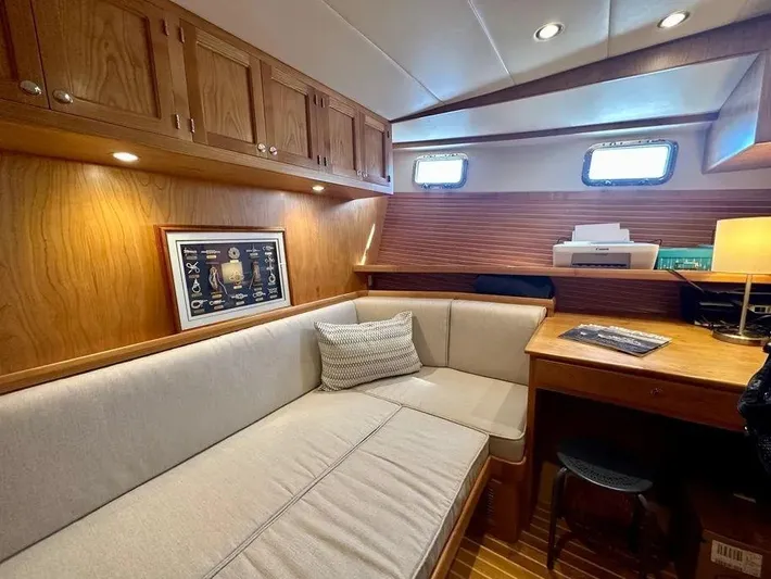 Carmella Yacht Photos Pics Cozy interior of 2019 Kadey-Krogen 44AE yacht with wood cabinetry and seating area.