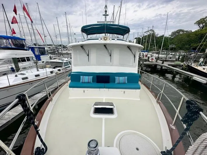 Carmella Yacht Photos Pics Kadey-Krogen 44AE 2019 yacht with blue seating, docked at a marina.