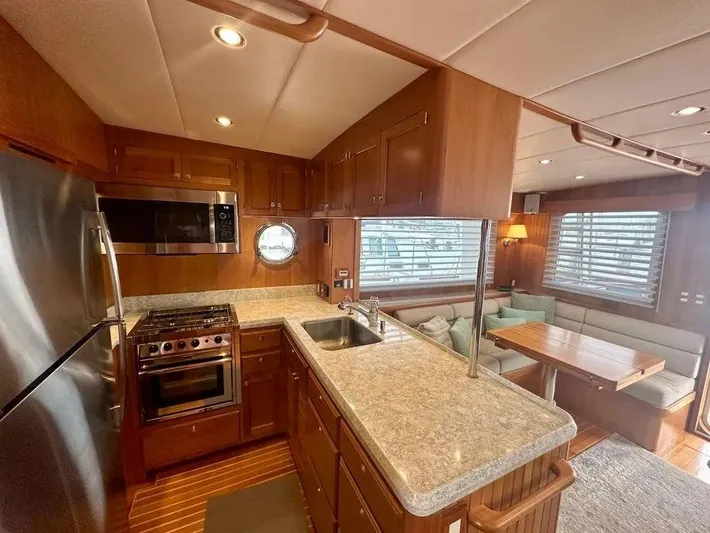 Carmella Yacht Photos Pics Luxurious 2019 Kadey-Krogen 44AE yacht interior with modern kitchen and cozy dining area.