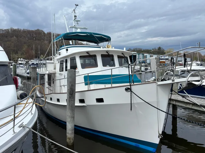 Carmella Yacht Photos Pics 2019 Kadey-Krogen 44AE yacht docked at marina under cloudy sky.
