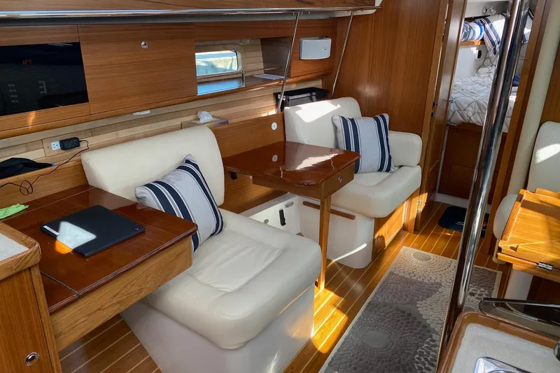 Sea Fever IV Yacht Photos Pics Luxurious interior of 2022 Catalina 355 sailboat with plush seating and wooden finishes.