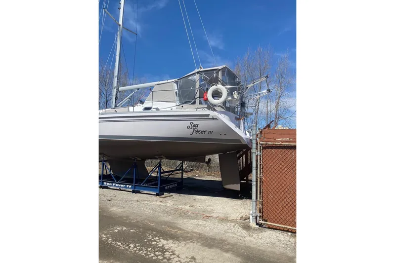 Sea Fever IV Yacht Photos Pics Catalina 355 sailboat, 2022 model, named "Sea Fever IV" on a stand outdoors.