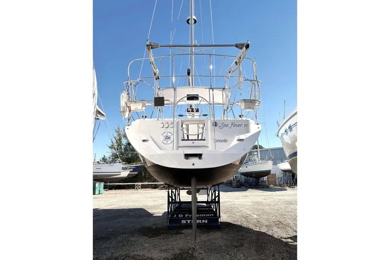 Sea Fever IV Yacht Photos Pics 2022 Catalina 355 sailboat on dry dock, rear view, clear sky background.