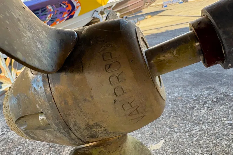 Sea Fever IV Yacht Photos Pics Close-up of a Catalina 355 sailboat propeller, model year 2022, on a gravel surface.