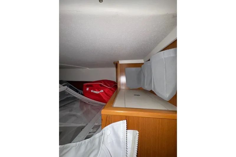 Sea Fever IV Yacht Photos Pics Interior storage area of a 2022 Catalina 355 sailboat with organized compartments.