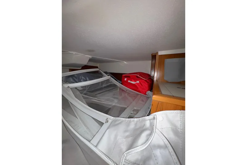 Sea Fever IV Yacht Photos Pics Interior storage area of a 2022 Catalina 355 sailboat with bags and equipment.