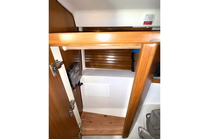 Sea Fever IV Yacht Photos Pics 2022 Catalina 355 interior cabinet with wooden finish and storage space.