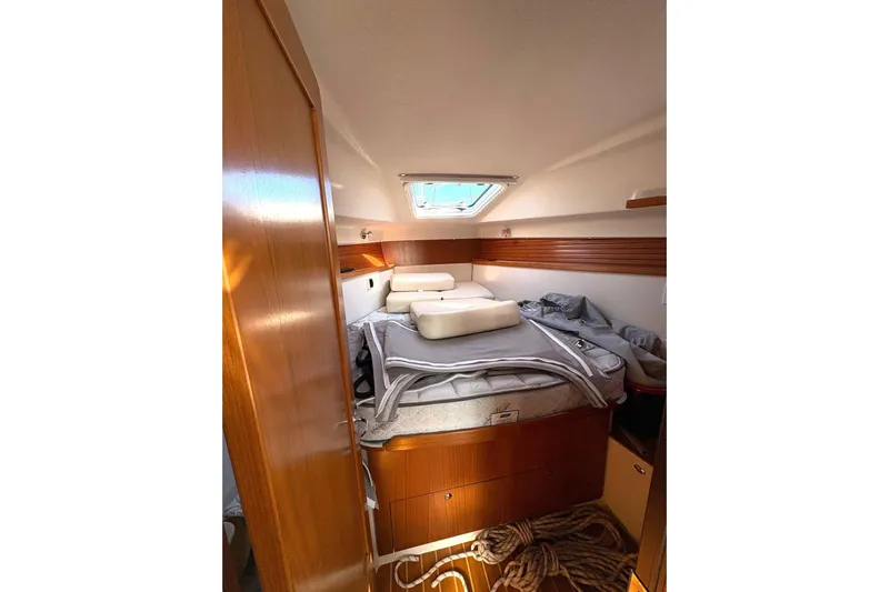 Sea Fever IV Yacht Photos Pics Cozy cabin interior of 2022 Catalina 355 sailboat with wooden finish and bedding.
