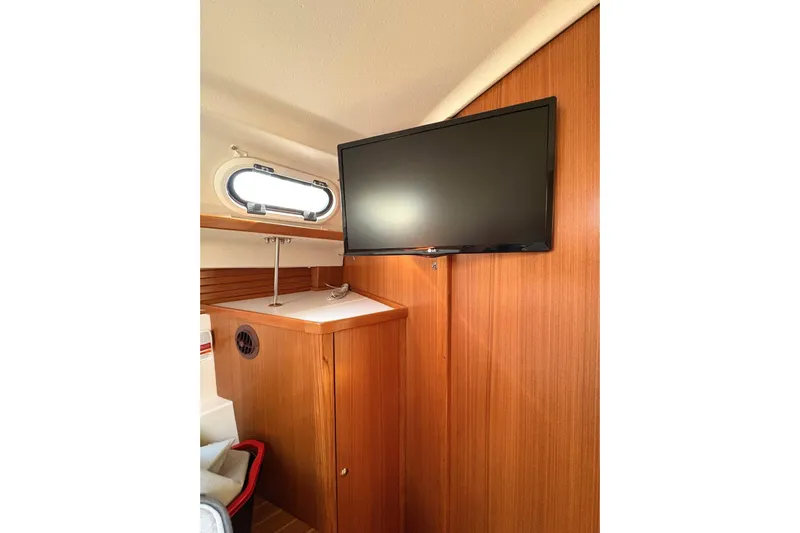 Sea Fever IV Yacht Photos Pics Interior of 2022 Catalina 355 yacht with mounted TV and wooden cabinetry.