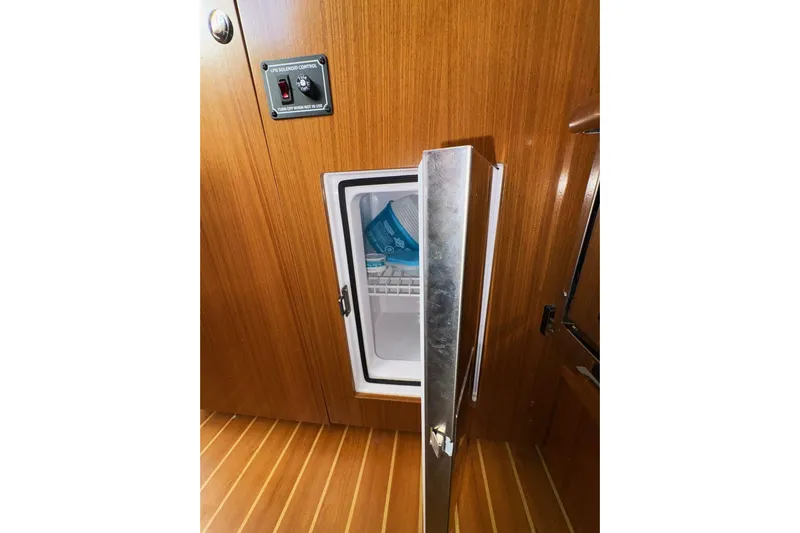 Sea Fever IV Yacht Photos Pics Catalina 355 yacht interior with open fridge, showcasing wooden cabinetry, 2022 model.