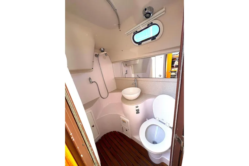 Sea Fever IV Yacht Photos Pics Modern bathroom in 2022 Catalina 355 yacht with shower, sink, and toilet.