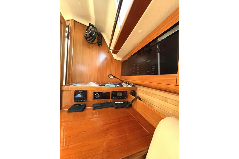 Sea Fever IV Yacht Photos Pics Interior of 2022 Catalina 355 sailboat with navigation equipment and wooden finish.