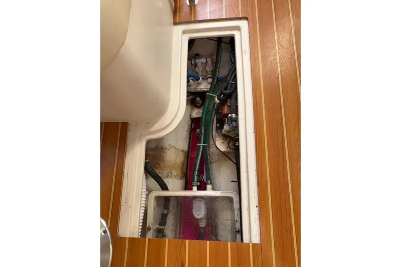 Sea Fever IV Yacht Photos Pics Engine compartment of a 2022 Catalina 355 sailboat with visible wiring and hoses.