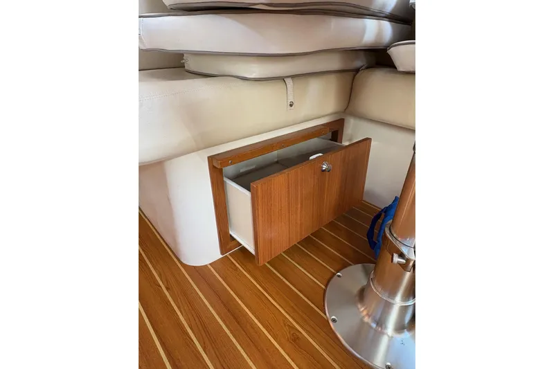 Sea Fever IV Yacht Photos Pics 2022 Catalina 355 interior with open wooden storage compartment and cushioned seating.