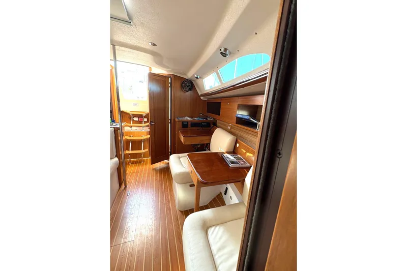 Sea Fever IV Yacht Photos Pics Interior of 2022 Catalina 355 sailboat with wood finish and seating area.