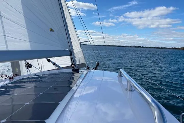 Sea Fever IV Yacht Photos Pics Sailing on a 2022 Catalina 355 yacht with solar panels under a clear blue sky.