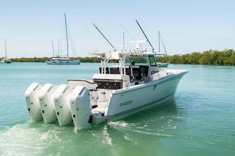  Yacht Photos Pics 2024 Blackfin 400CC boat with four engines cruising in clear blue water.