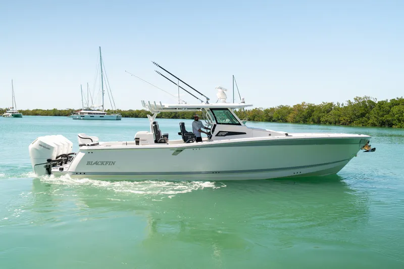  Yacht Photos Pics 2024 Blackfin 400CC boat cruising on calm turquoise waters.