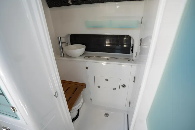  Yacht Photos Pics 2024 Blackfin 400CC boat interior bathroom with modern sink and wooden accents.