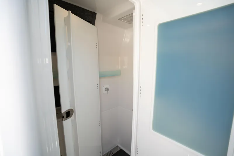  Yacht Photos Pics 2024 Blackfin 400CC interior shower with modern design and sleek white finish.