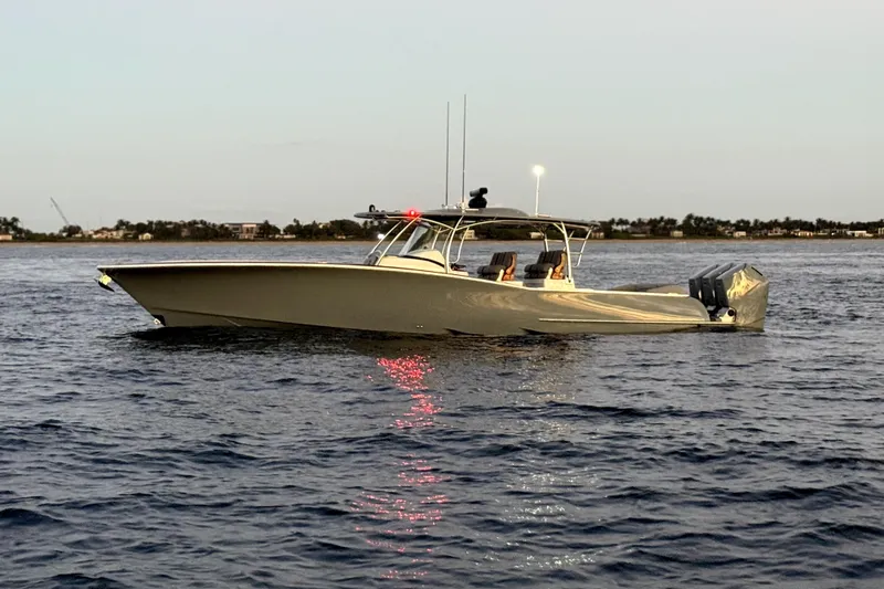  Yacht Photos Pics 2026 Mag Bay 43 CC boat on calm water at sunset.