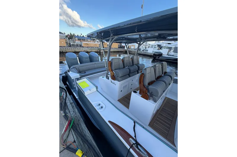  Yacht Photos Pics 2026 Mag Bay 43 CC boat with luxurious seating and multiple engines docked at marina.