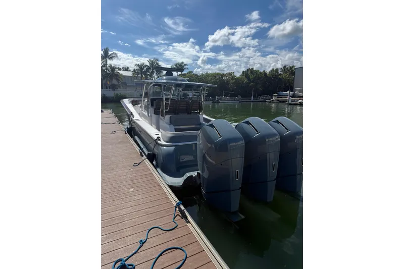  Yacht Photos Pics 2026 Mag Bay 43 CC boat docked with triple outboard engines under a clear sky.
