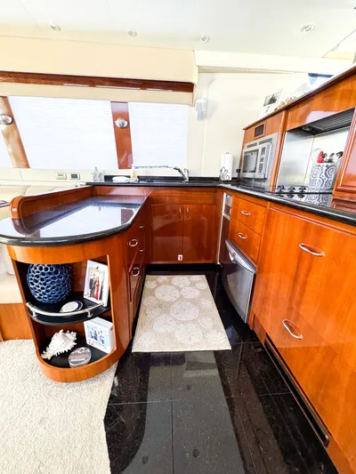 Social Distancing Yacht Photos Pics 2006 Carver 560 Voyager kitchen with modern appliances and wooden cabinetry.