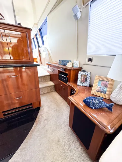 Social Distancing Yacht Photos Pics Interior of a 2006 Carver 560 Voyager yacht with wooden cabinetry and carpeted flooring.