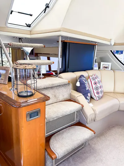 Social Distancing Yacht Photos Pics Interior of 2006 Carver 560 Voyager yacht with beige seating and decorative pillows.