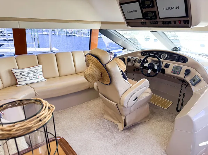 Social Distancing Yacht Photos Pics Interior of a 2006 Carver 560 Voyager yacht with beige leather seating and Garmin navigation.