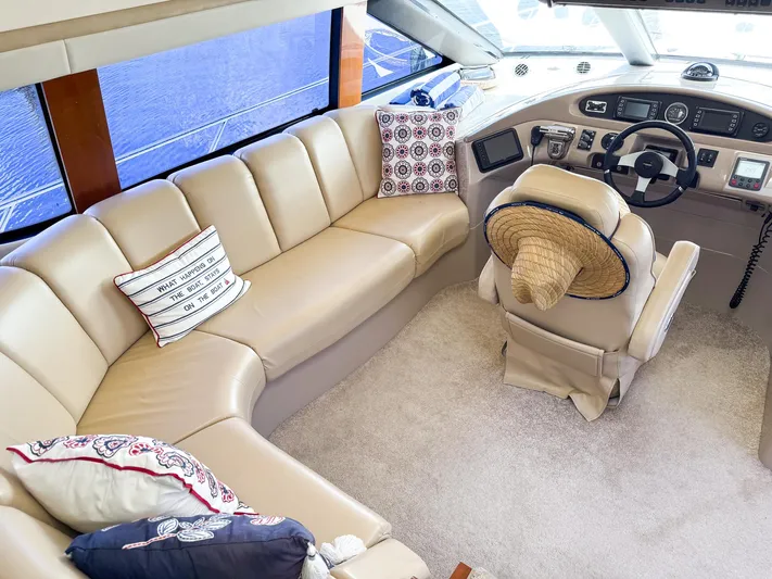 Social Distancing Yacht Photos Pics Interior of 2006 Carver 560 Voyager yacht with beige leather seating and helm.
