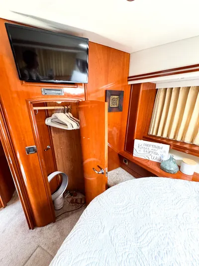 Social Distancing Yacht Photos Pics Luxurious interior of a 2006 Carver 560 Voyager yacht bedroom with TV and closet.