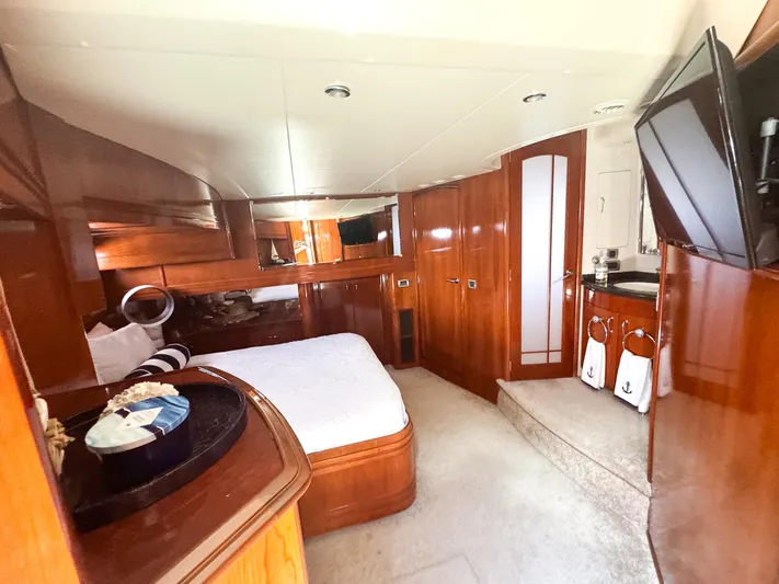 Social Distancing Yacht Photos Pics Luxurious bedroom interior of a 2006 Carver 560 Voyager yacht with wooden finishes.