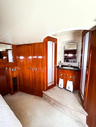 Social Distancing Yacht Photos Pics Luxurious interior of 2006 Carver 560 Voyager yacht with wooden cabinetry and vanity area.