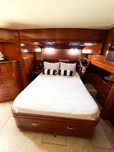 Social Distancing Yacht Photos Pics Luxurious bedroom interior of 2006 Carver 560 Voyager yacht with wooden cabinetry.