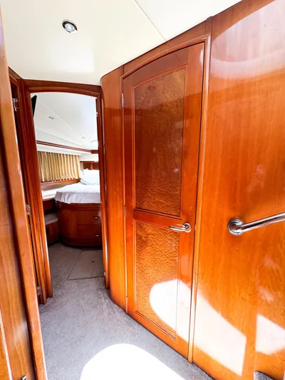 Social Distancing Yacht Photos Pics Interior of 2006 Carver 560 Voyager yacht with wooden doors and cozy bedroom.