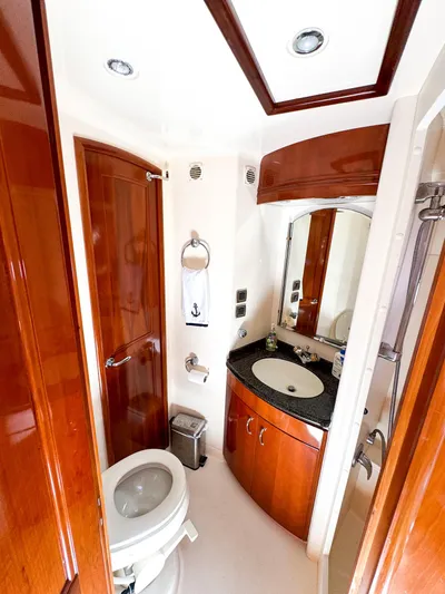 Social Distancing Yacht Photos Pics Luxurious bathroom in 2006 Carver 560 Voyager yacht with wood accents and modern fixtures.