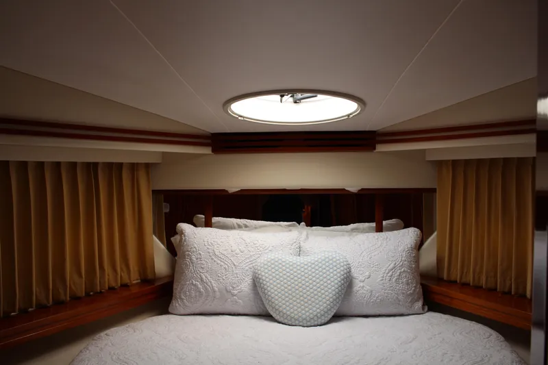 Social Distancing Yacht Photos Pics Luxurious bedroom interior of 2006 Carver 56 Voyager yacht with elegant bedding.