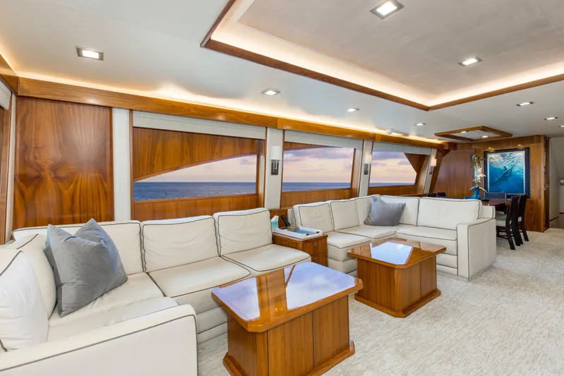 Touche Yacht Photos Pics Luxurious interior of 2016 Viking 92 Enclosed Bridge yacht with elegant seating and ocean view.