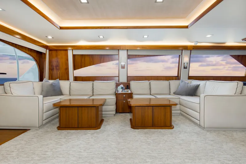 Touche Yacht Photos Pics Luxurious interior of 2016 Viking 92 Enclosed Bridge yacht with elegant seating and wooden accents.